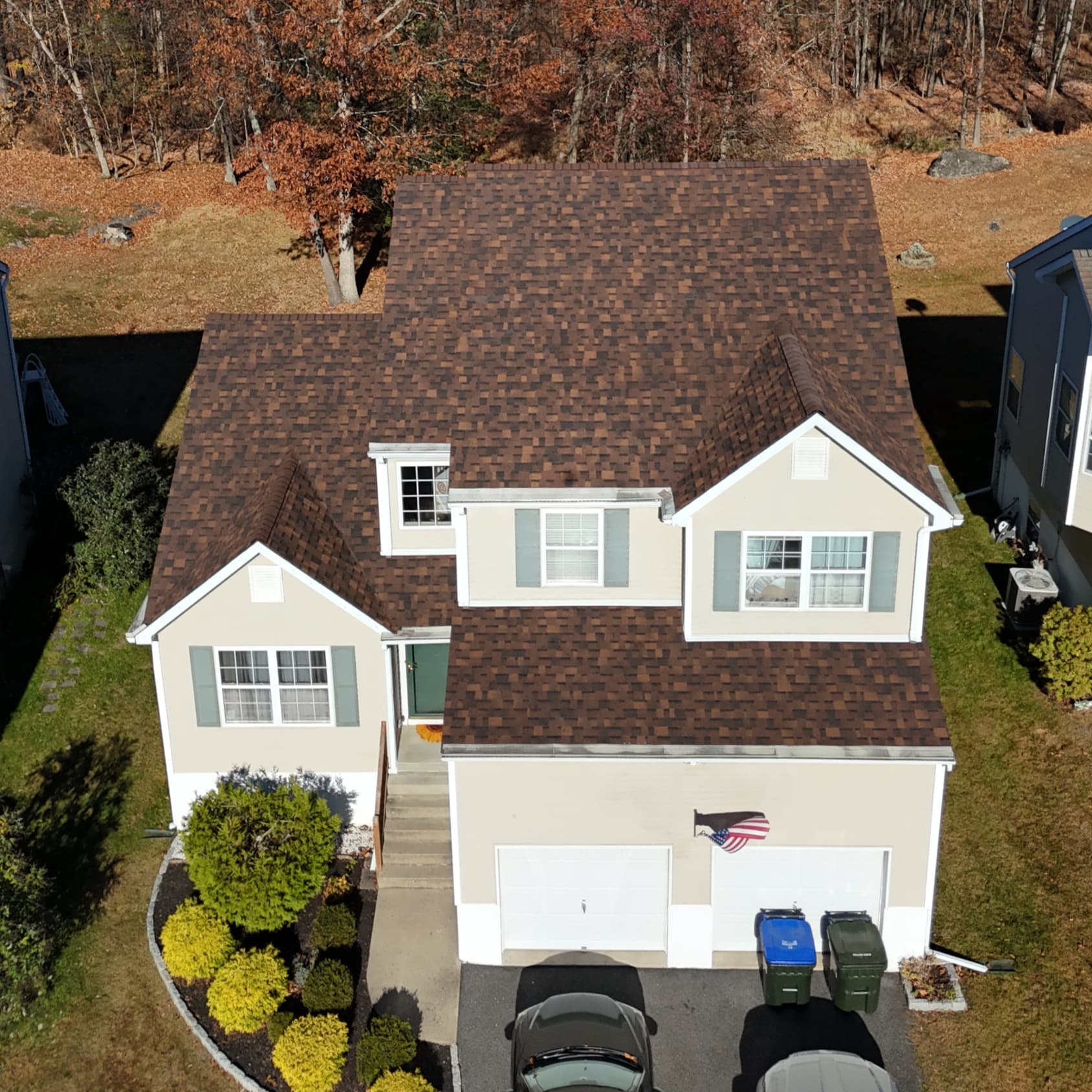 New brown shingle roof, gutters and trim on a white colonial in Washingtonville, NY